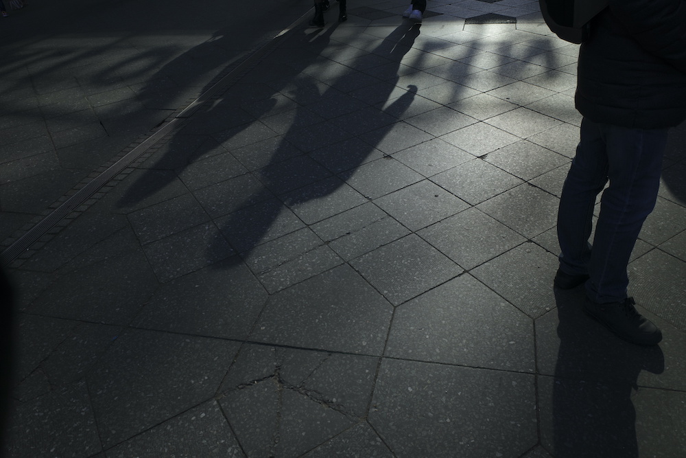 shadows walking sidewalk