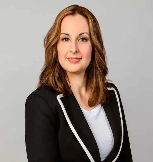 A professional woman wearing a business suit and white shirt, exuding confidence and readiness for the workplace.
